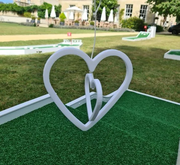 two swing heart entwinned together on mini golf course